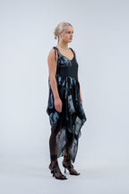 Woman wearing a black and gray Rhian silk patterned dress on a white background