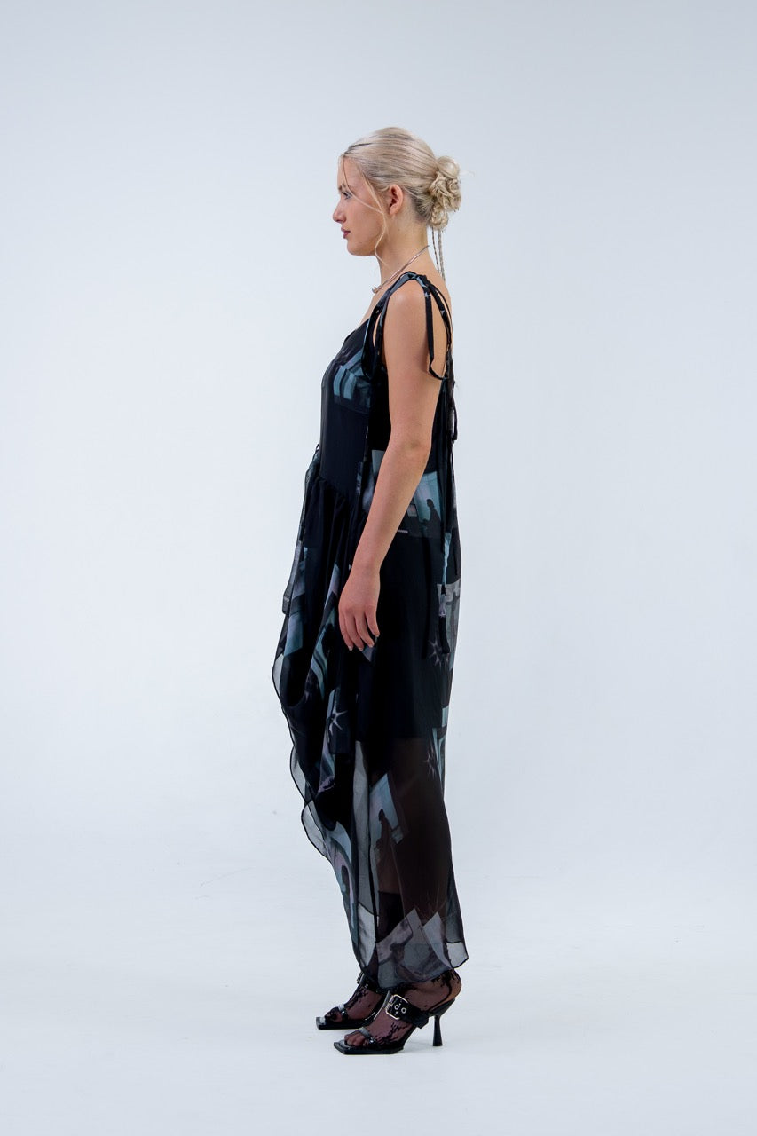 Woman wearing a black and gray Rhian silk patterned dress on a white background