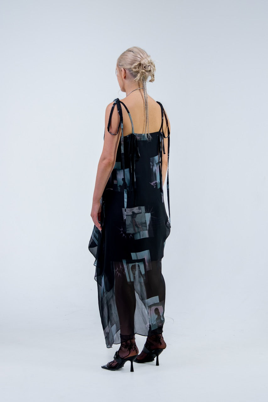 Woman wearing a black and gray Rhian silk patterned dress on a white background