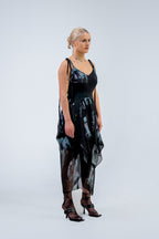 Woman wearing a black and gray Rhian silk patterned dress on a white background
