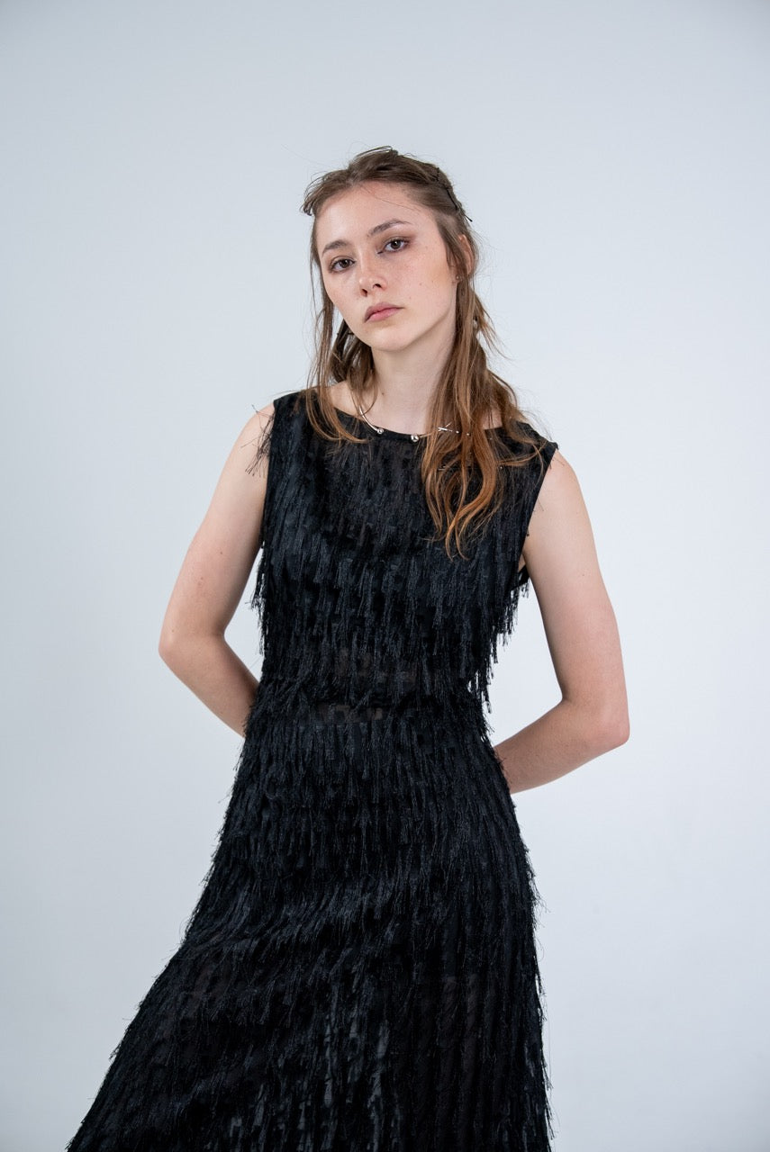 Person wearing a black sleeveless dress with fray details handmade by Rhian in Dunedin on a white background