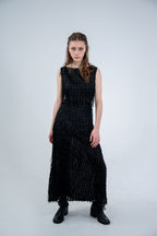 Person wearing a black sleeveless dress with fray details handmade by Rhian in Dunedin on a white background
