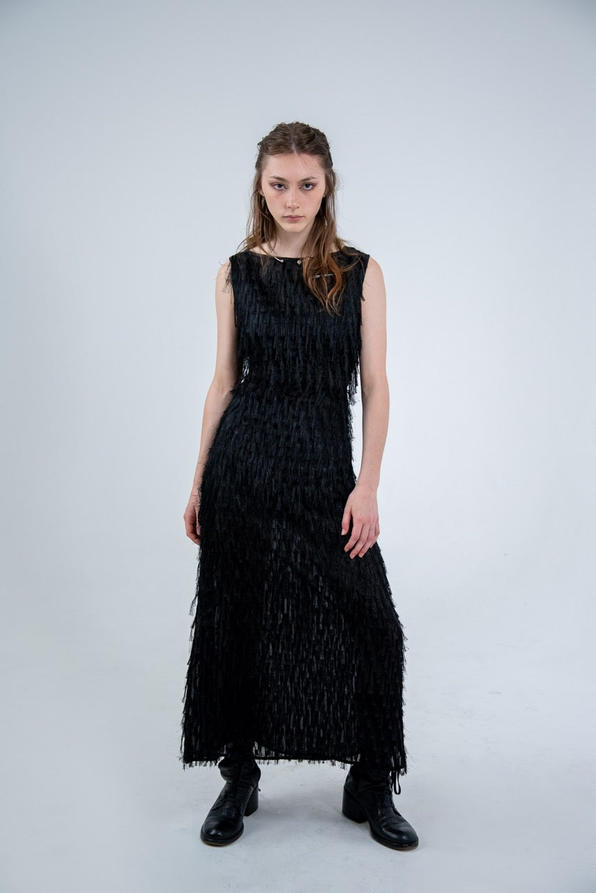 Person wearing a black sleeveless dress with fray details handmade by Rhian in Dunedin on a white background