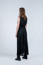Person wearing a black sleeveless dress with fray details handmade by Rhian in Dunedin on a white background