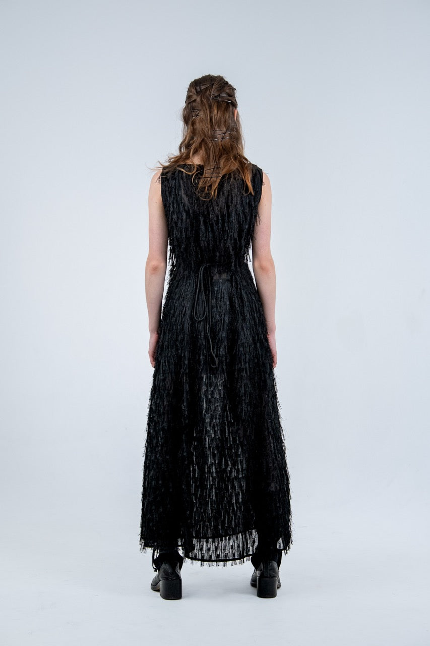 Person wearing a black sleeveless dress with fray details handmade by Rhian in Dunedin on a white background