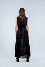 Person wearing a black sleeveless dress with fray details handmade by Rhian in Dunedin on a white background