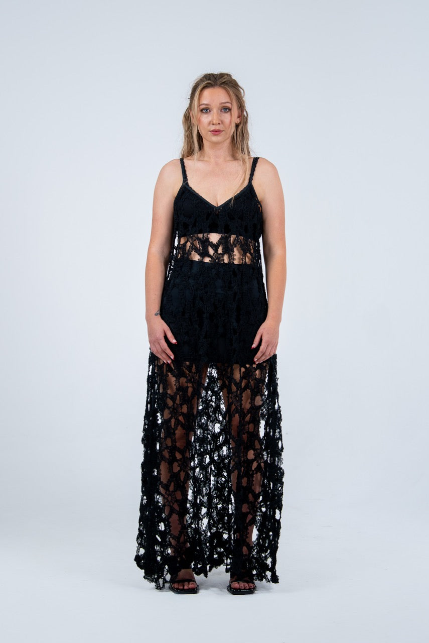 Woman wearing a black lace dress by Rhian on a white background