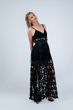 Woman wearing a black lace dress by Rhian on a white background