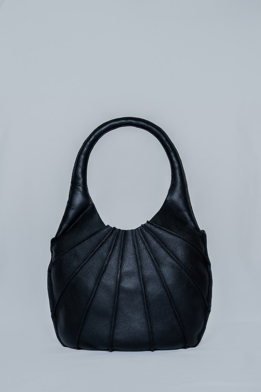 Black handbag on a light gray background