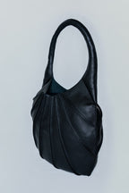 Black leather handbag on a light gray background