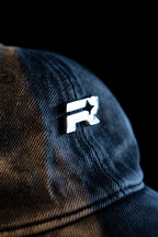 Blue and brown checkered cap with a white logo on a black background