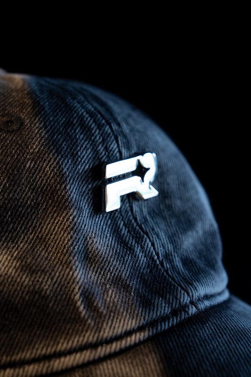 Blue and brown checkered cap with a white logo on a black background