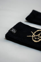 Black wristbands with gold logo on a light gray background